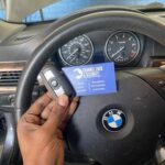 BMW key fob in front of steering wheel