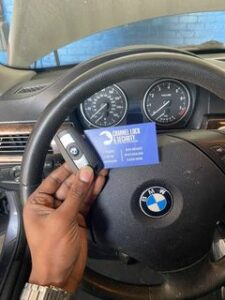 BMW key fob in front of steering wheel
