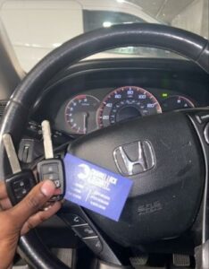 Honda key infront of steering wheel